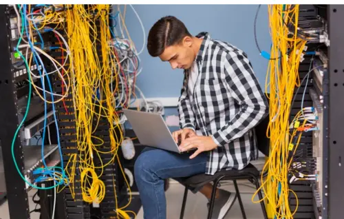IT engineer checking structured cabling system in server room