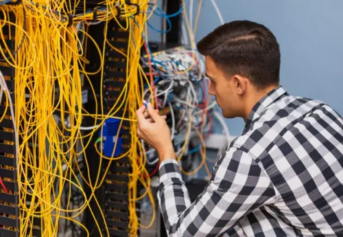 Structured cabling technician organizing network cables
